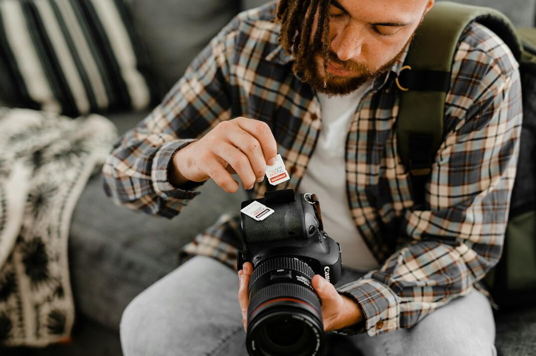 Photographer reviewing contact sheets and editing photos on a laptop