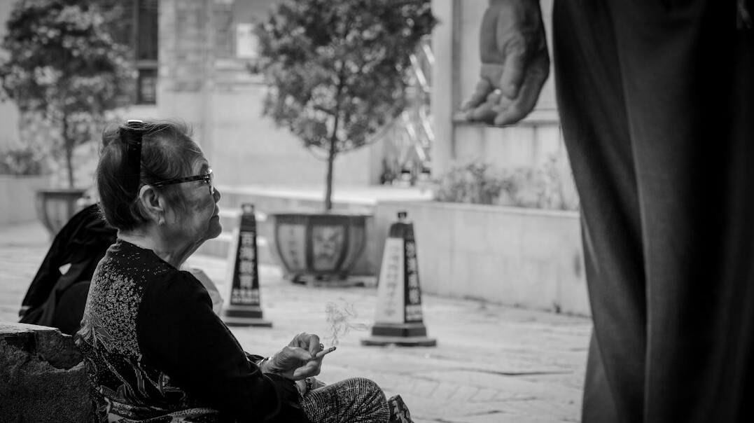 Documentary photographer photographing an elderly woman in a Polish village